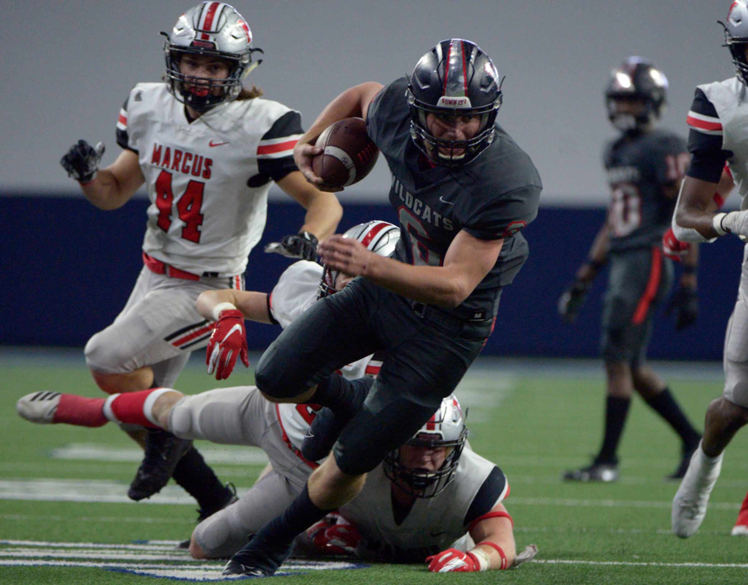 Lake Highlands quarterback Mitch Coulson (6) looks for running room through the Flower Mound...