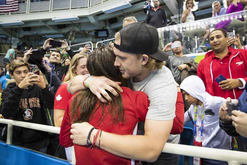 Dallas Stars defenseman Jamie Oleksiak hugs his sister Penny Oleksiak of Canada after she...