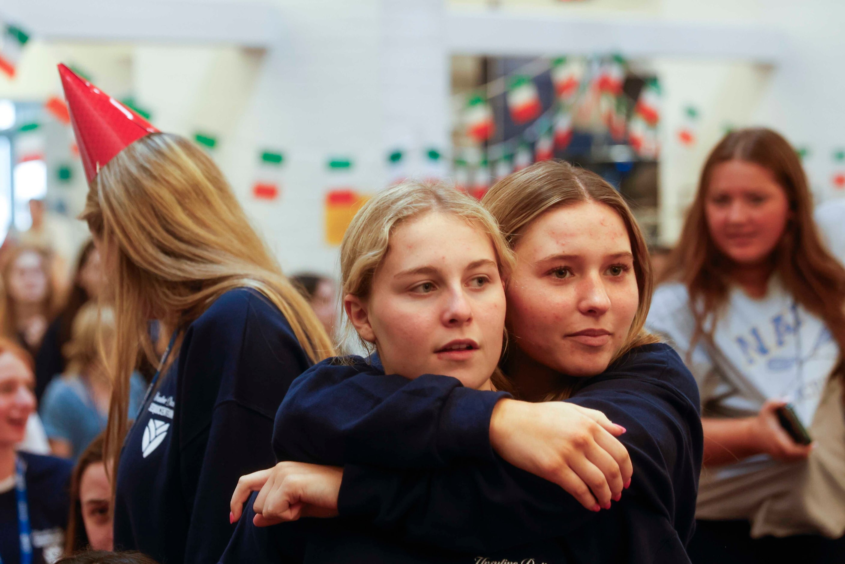 Students Kate Thornton (left) gets a hug from Gianna Ferri as they get ready for a...