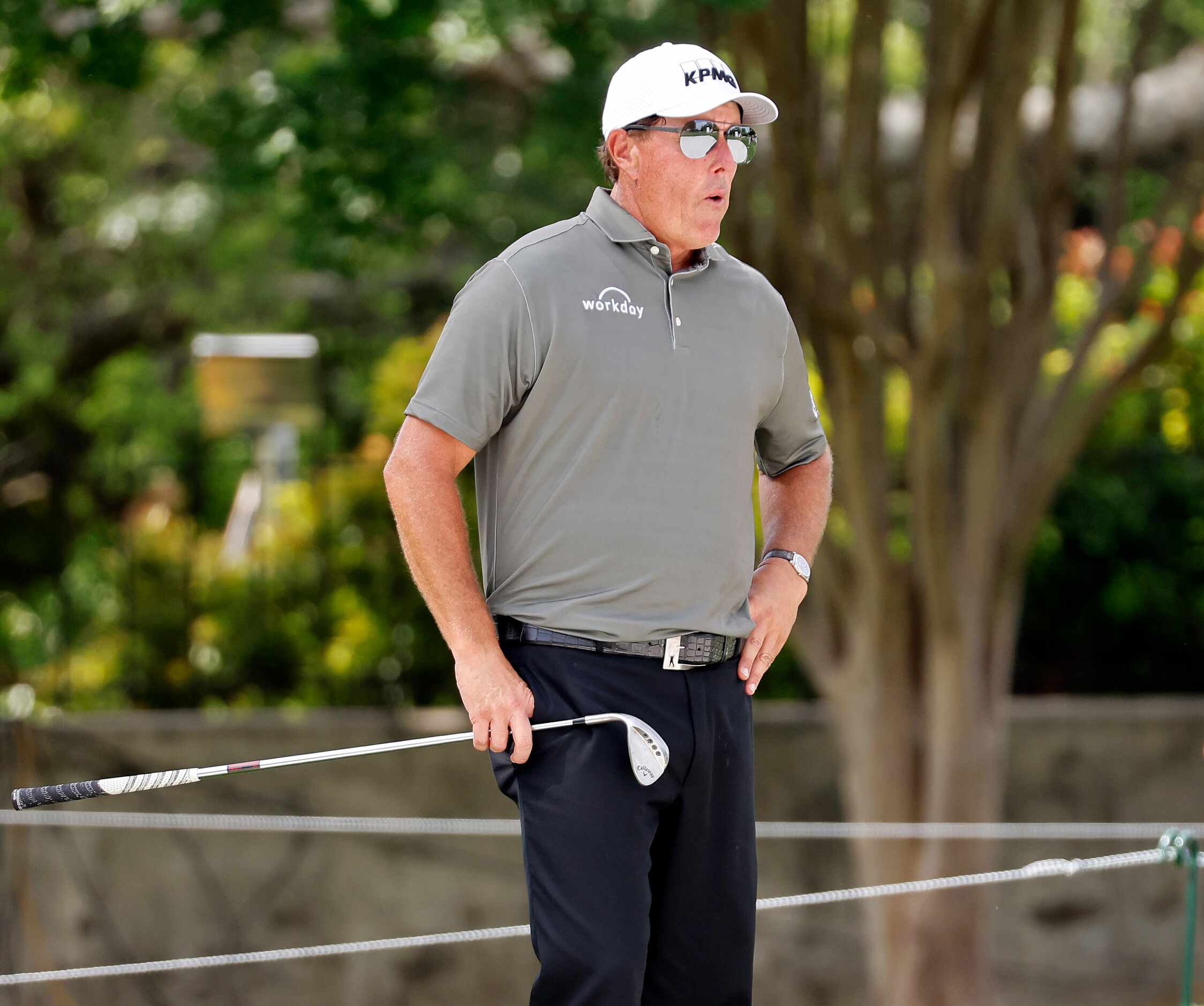 Professional golfer Phil Mickelson takes a deep breath before hitting out of the green side...
