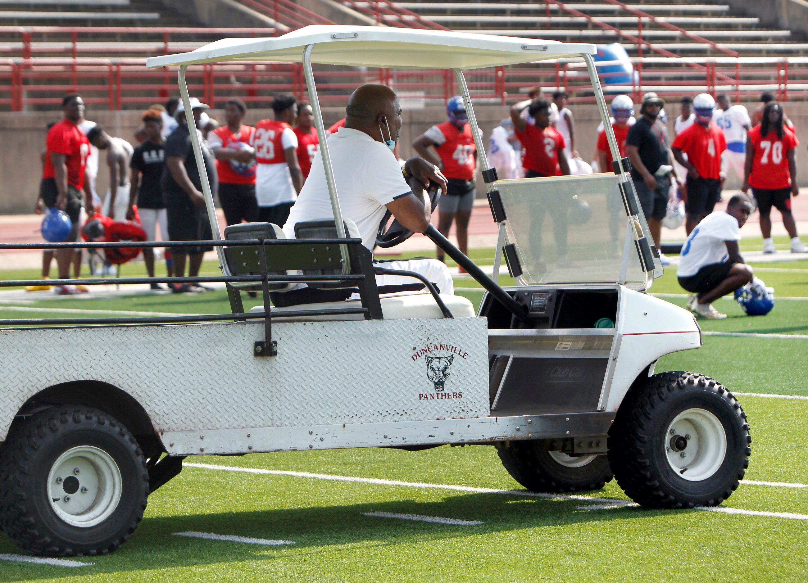 Duncanville panther head football coach Reginald Samples intently observes his varsity squad...