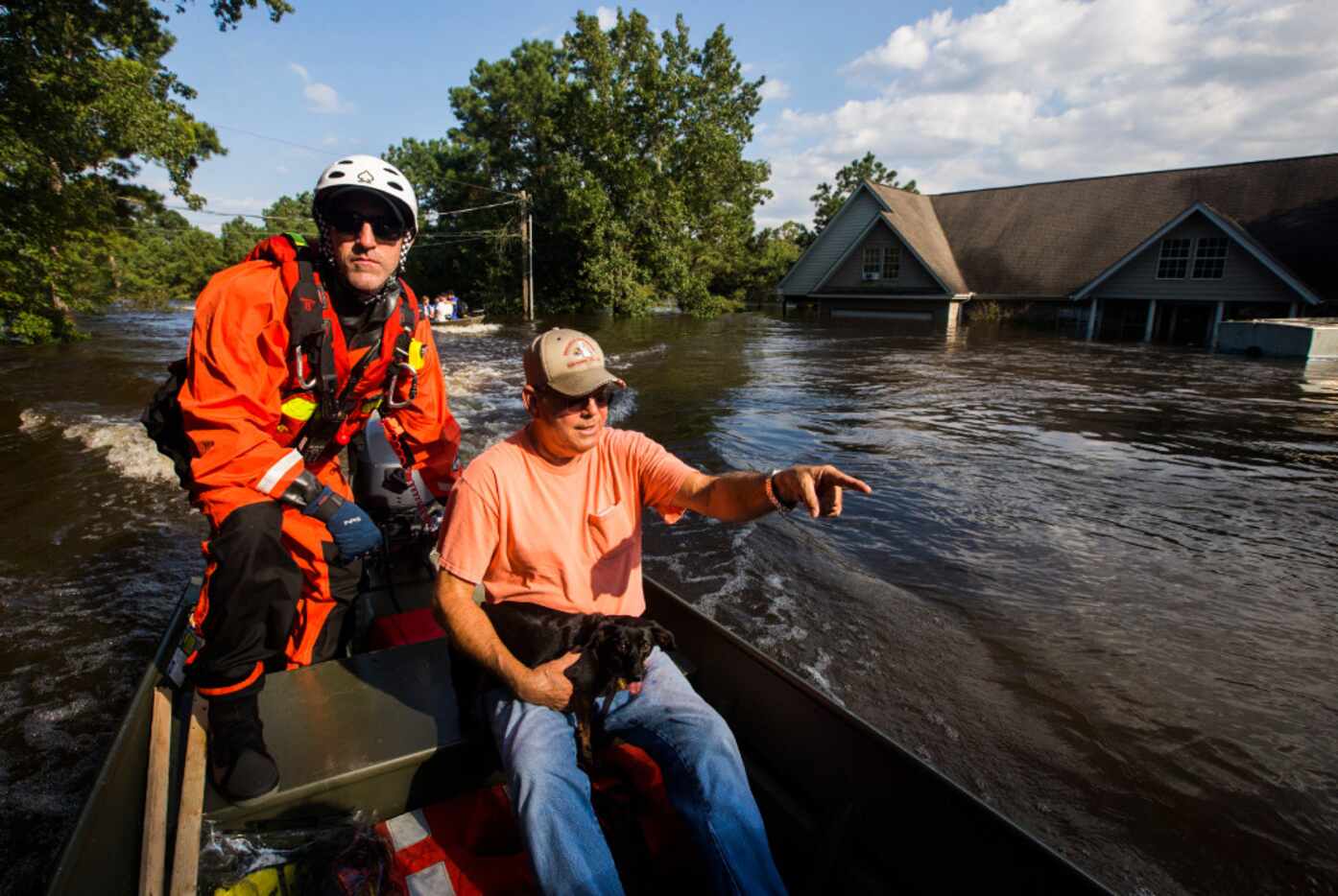Captain Jeremy Finney of Tampa Fire and Rescue (left) evacuates Earnest "Dobie" Walton from...