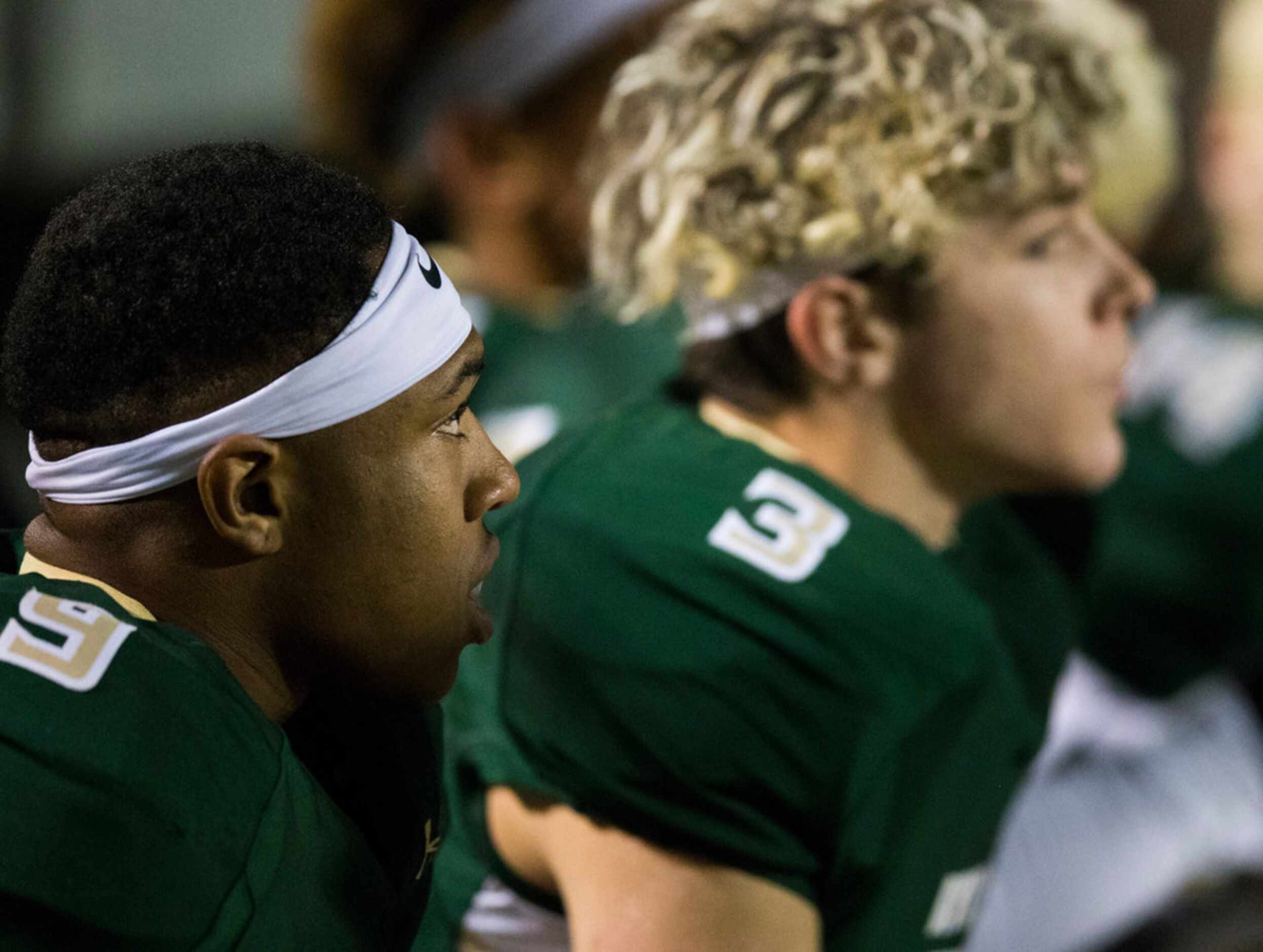 Birdville running back Laderrious Mixon (9) and quarterback Stone Earle (3) sit on the...