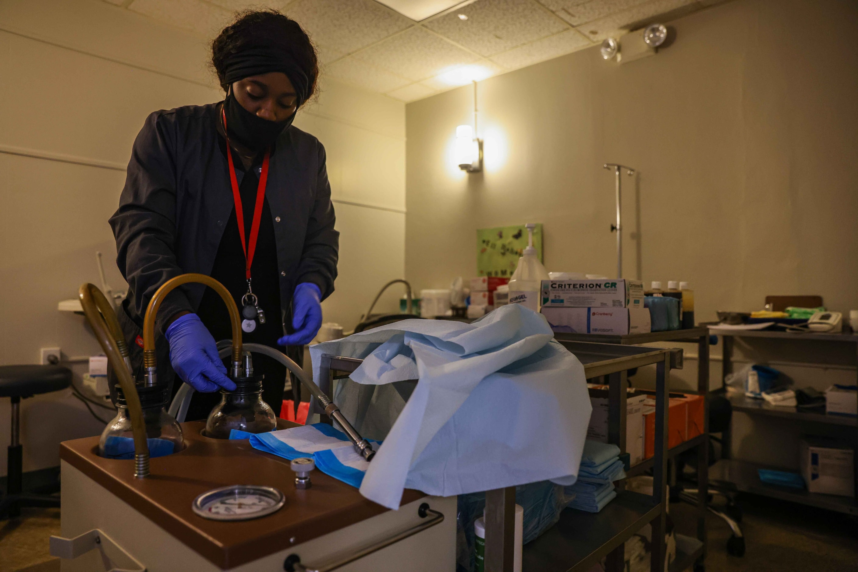 Symone Johnson prepares the vacuum aspiration machine at Hope Medical Group for Women.