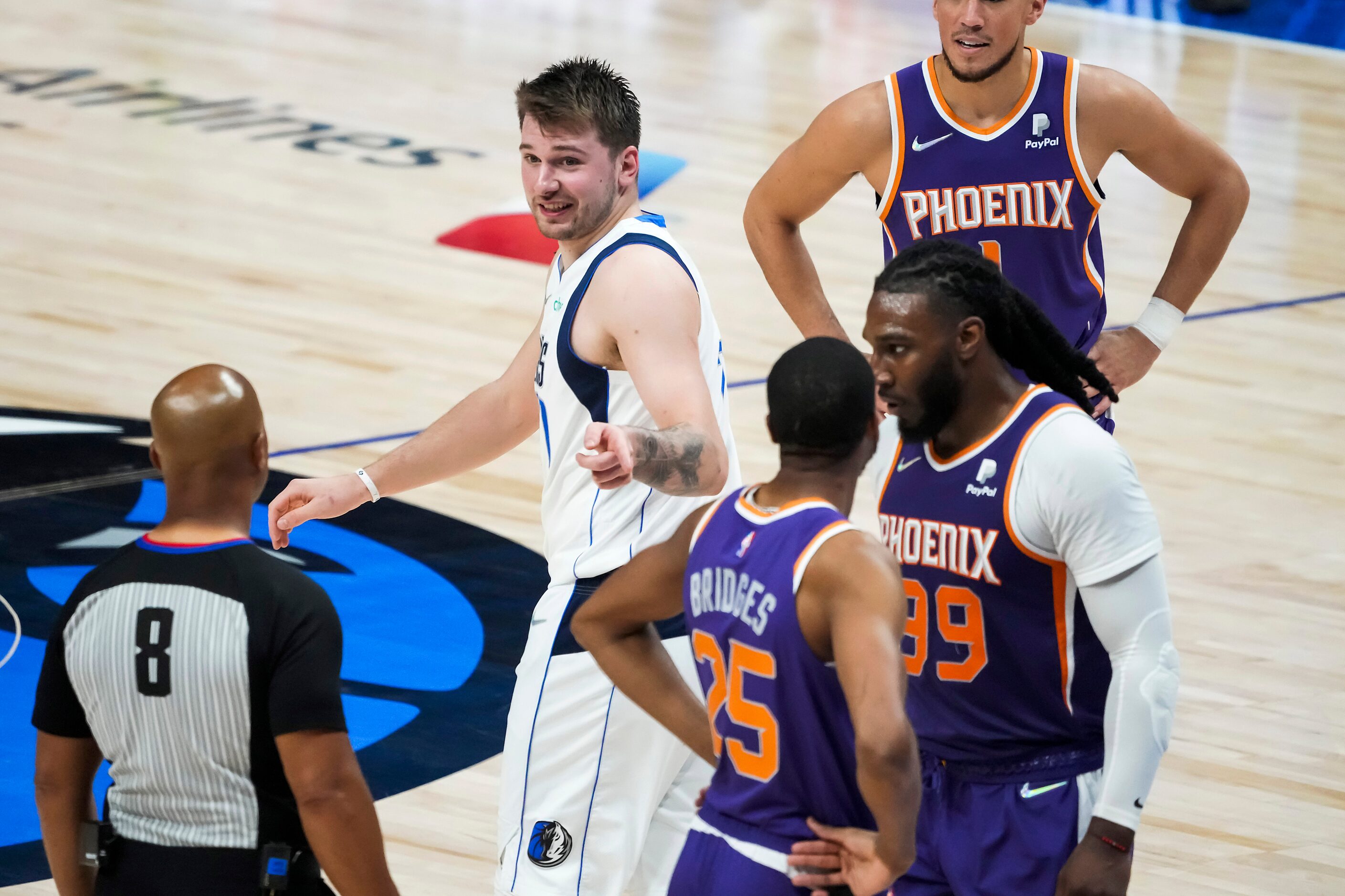 Dallas Mavericks guard Luka Doncic (77) gestures to an official and Phoenix Suns forward...