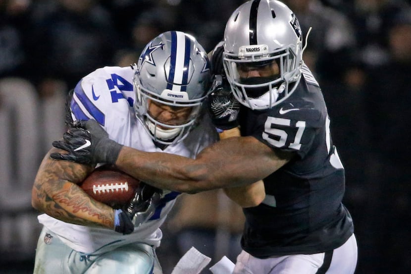 Dallas Cowboys fullback Keith Smith (41) fights for yardage as Oakland Raiders outside...