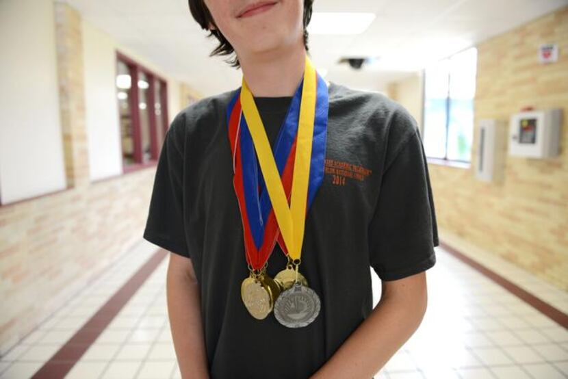
Eighth-grader Ryan Mann poses for a portrait with his Pentathlon medals at Austin Academy...