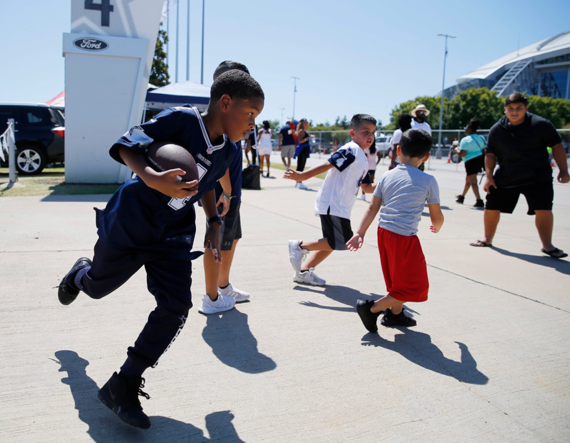 Jaidan Franklin, 9 of Red Oak turns the corner as he plays football with Ethan Garcia, 7...