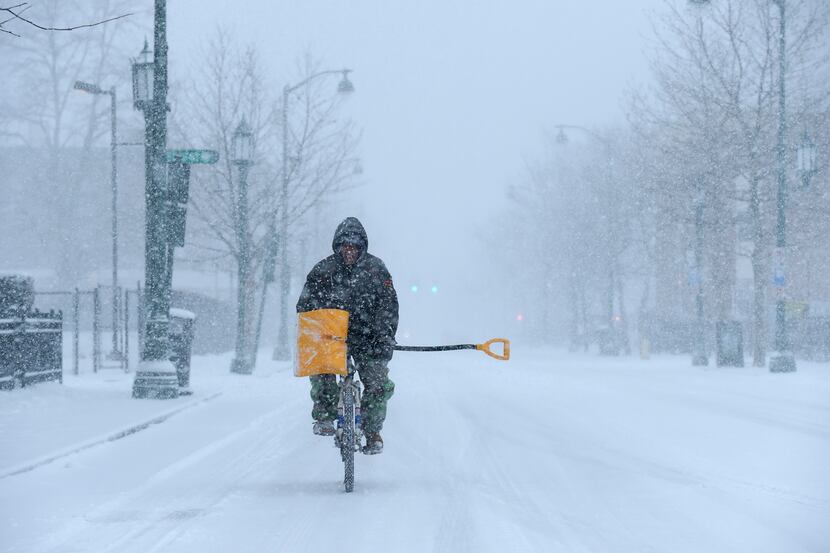 "I have snow tires," says Angel Ares, of Hartford, who bikes up Park Street in Hartford on...