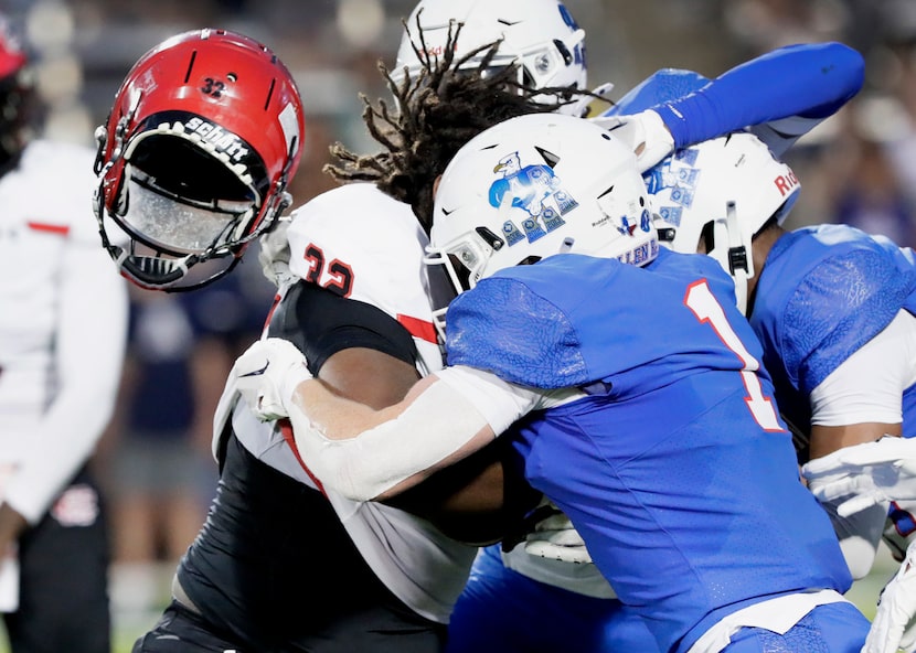 Cedar Hill High School High School running back Jalen Brewster (32) has his helmet knocked...