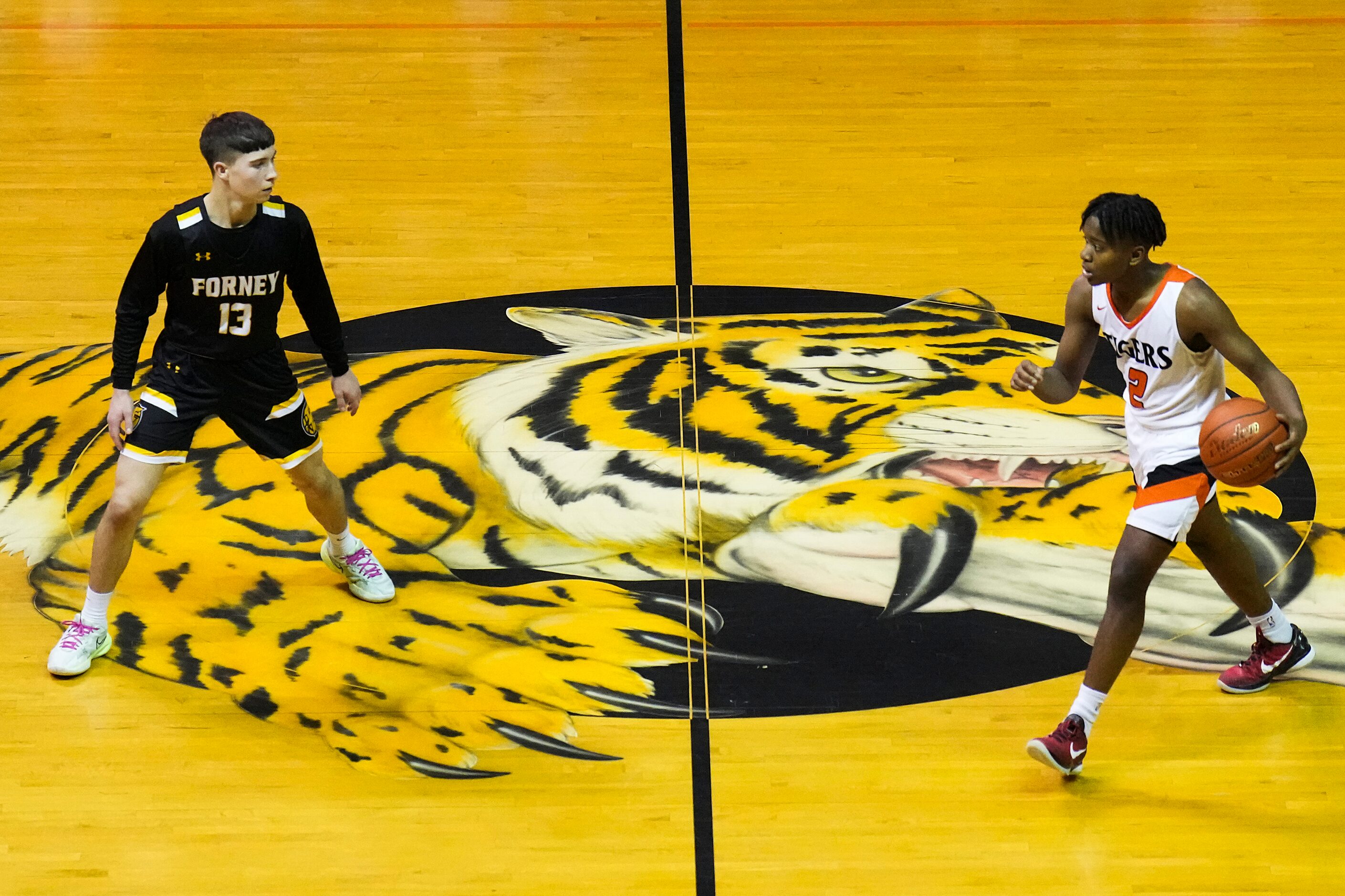 Lancaster's Khamari Ford (2) brings the ball up the court against Forney guard Jordan Fabian...