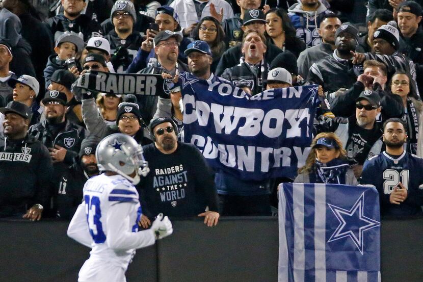 Cowboys fans cheer for their team during the Dallas Cowboys vs. the Oakland Raiders NFL...
