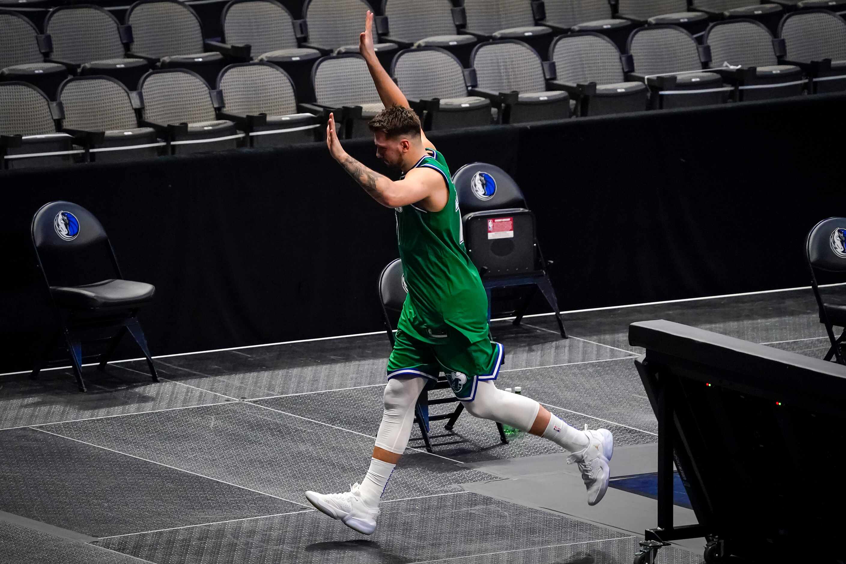 Dallas Mavericks guard Luka Doncic waves to the crowd as he leaves the court after the...