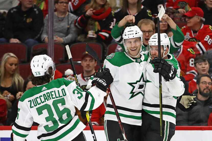 CHICAGO, ILLINOIS - FEBRUARY 24: Radek Faksa #12 of the Dallas Stars (R) celebrates a first...