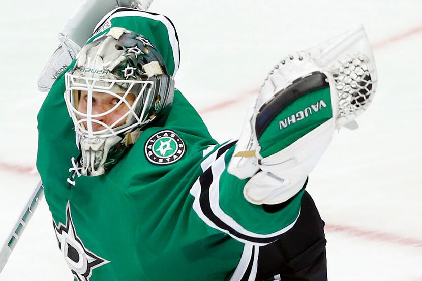 Dallas Stars goalie Antti Niemi (31) snares a shot on goal by the New York Islanders during...