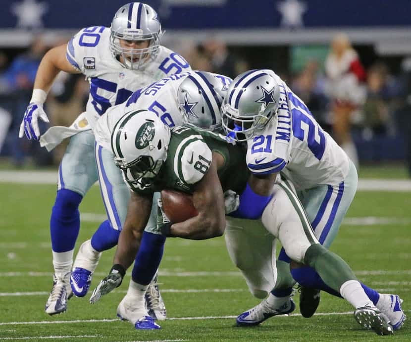 Dallas Cowboys Sean Lee (50), Anthony Hitchens (59) and Terrance Mitchell (21) combine to...