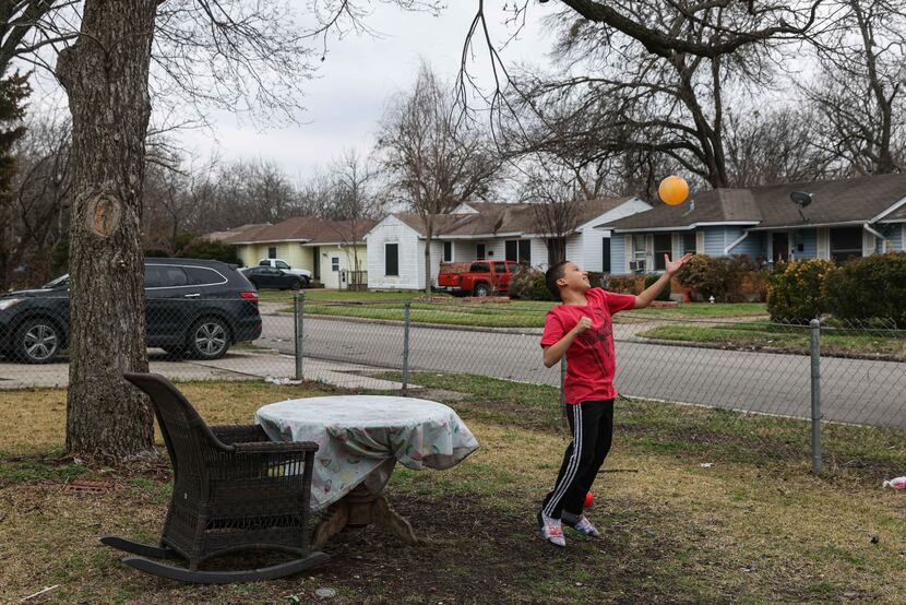 Aaron Hall, 11, who is on the autism spectrum, plays with a plastic ball at his front yard...