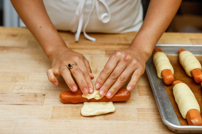 Jinny Cho, owner of Detour Doughnuts, prepares jalapeño pigs in a blanket at her shop in...