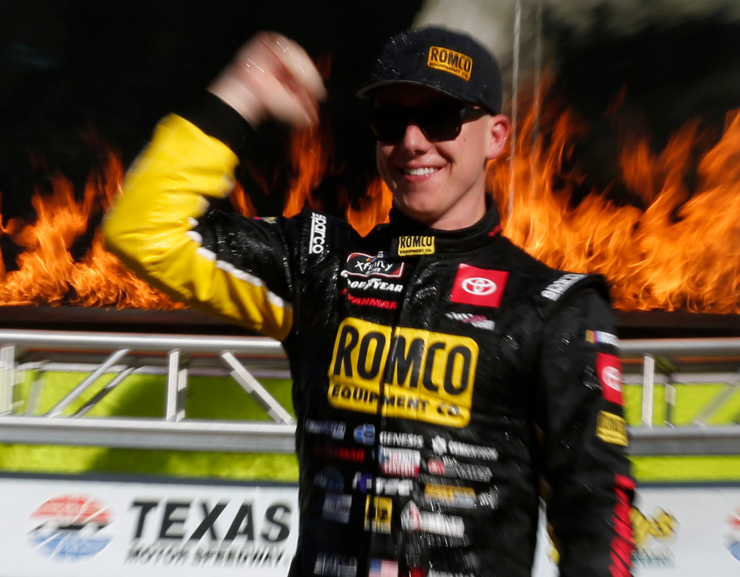John Hunter Nemechek pumps his fist from the winners circle after capturing the checkered...