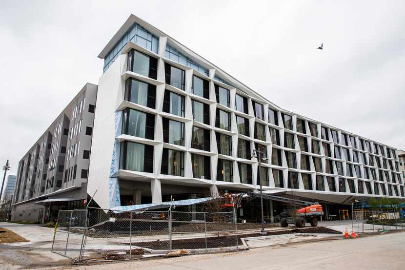 Construction workers put finishing touches on the exterior of the AC Hotel, which  recently...