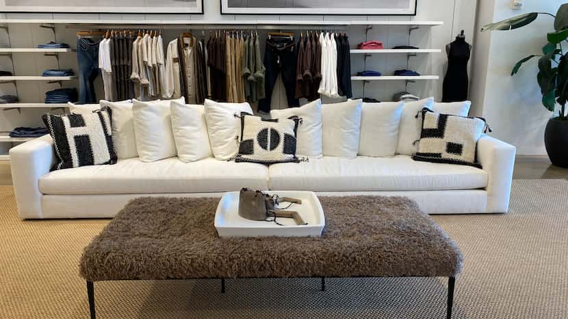 Furniture is displayed along with women's and men's apparel in the Banana Republic store in...