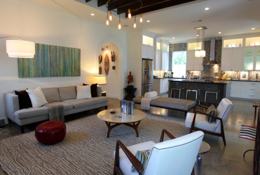 The living room and kitchen are white with brown, tan and gray accents. A long...