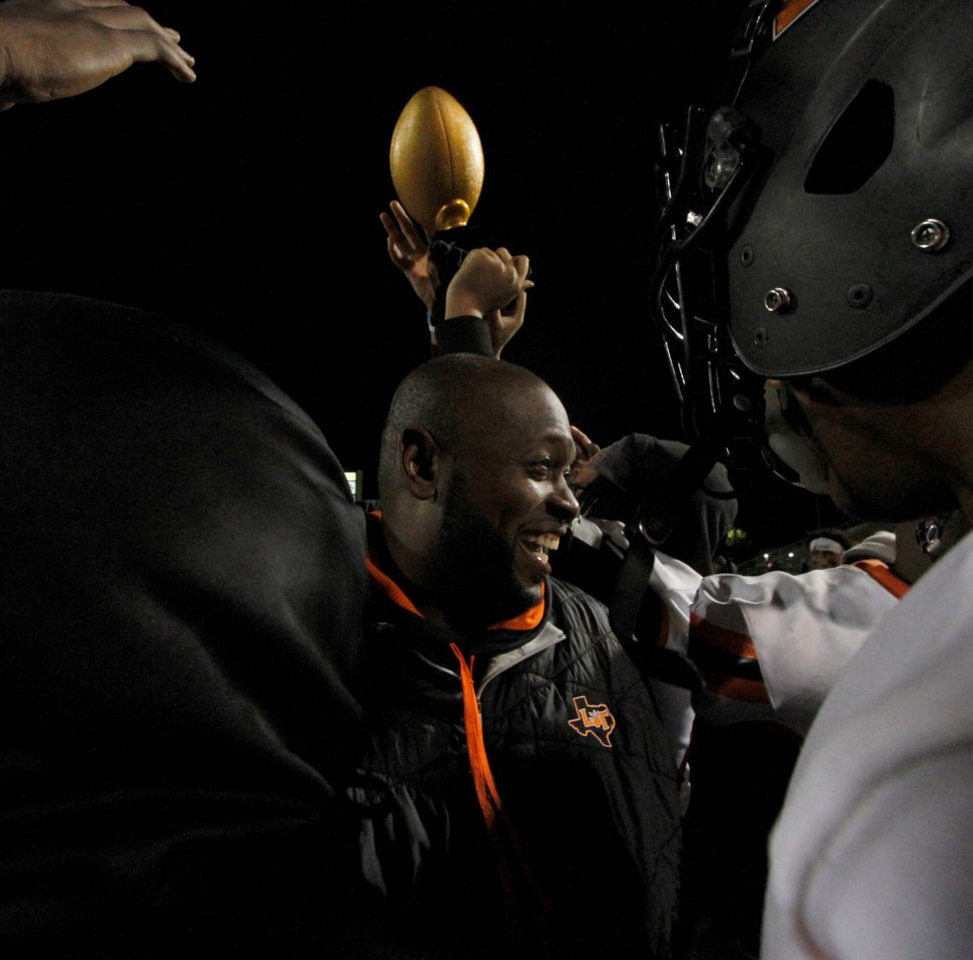 Lancaster head coach Chris Gilbert was all smiles as Tigers celebrate after being presented...