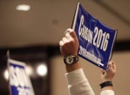  A Ben Carson supporter holds a sign while Carson speaks at a town hall meeting hosted by...