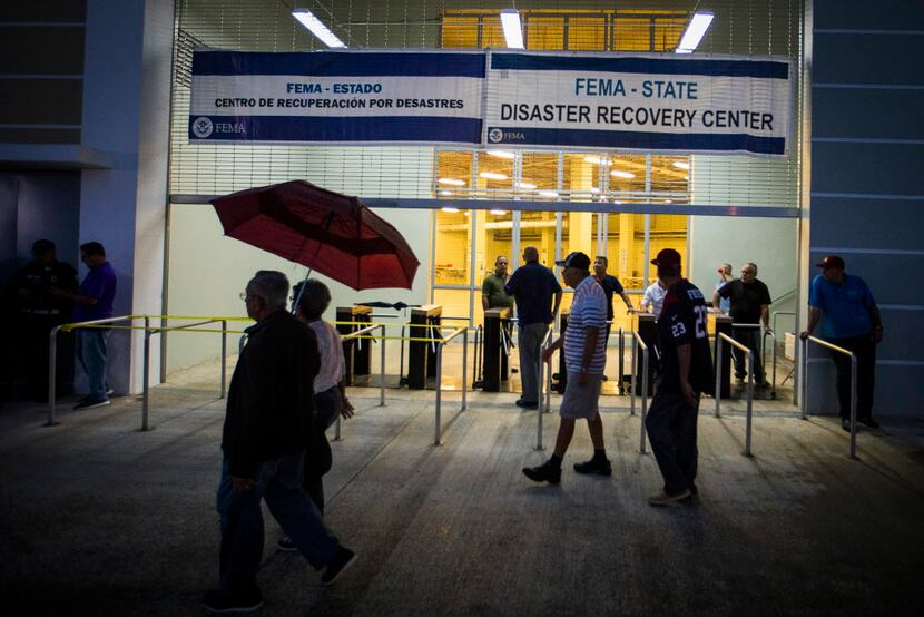 Signs designating the stadium as a FEMA Disaster Recovery Center hang above the turnstiles...
