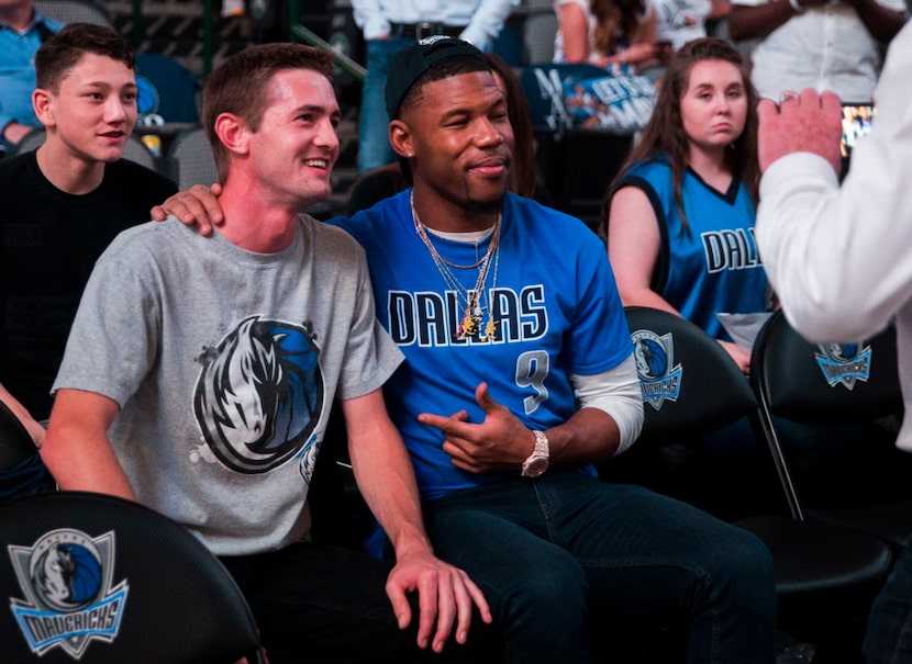 Dallas Cowboys wide receiver Terrance Williams, center, poses with a fan during halftime of...