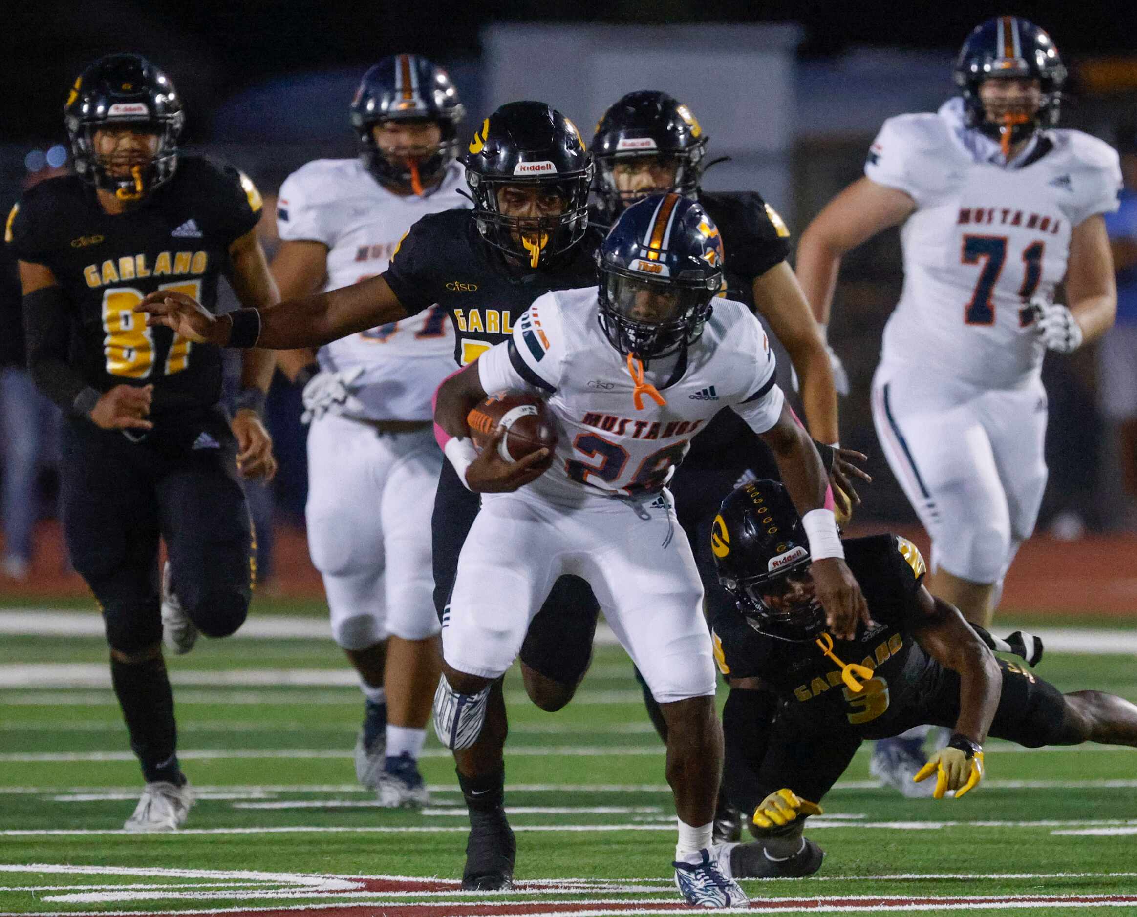 Sachse high school’s Brendon Haygood (28) runs with the ball past Garland high school’s...