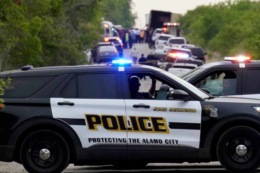 Police block the scene where a semitrailer with multiple dead bodies was discovered, Monday,...