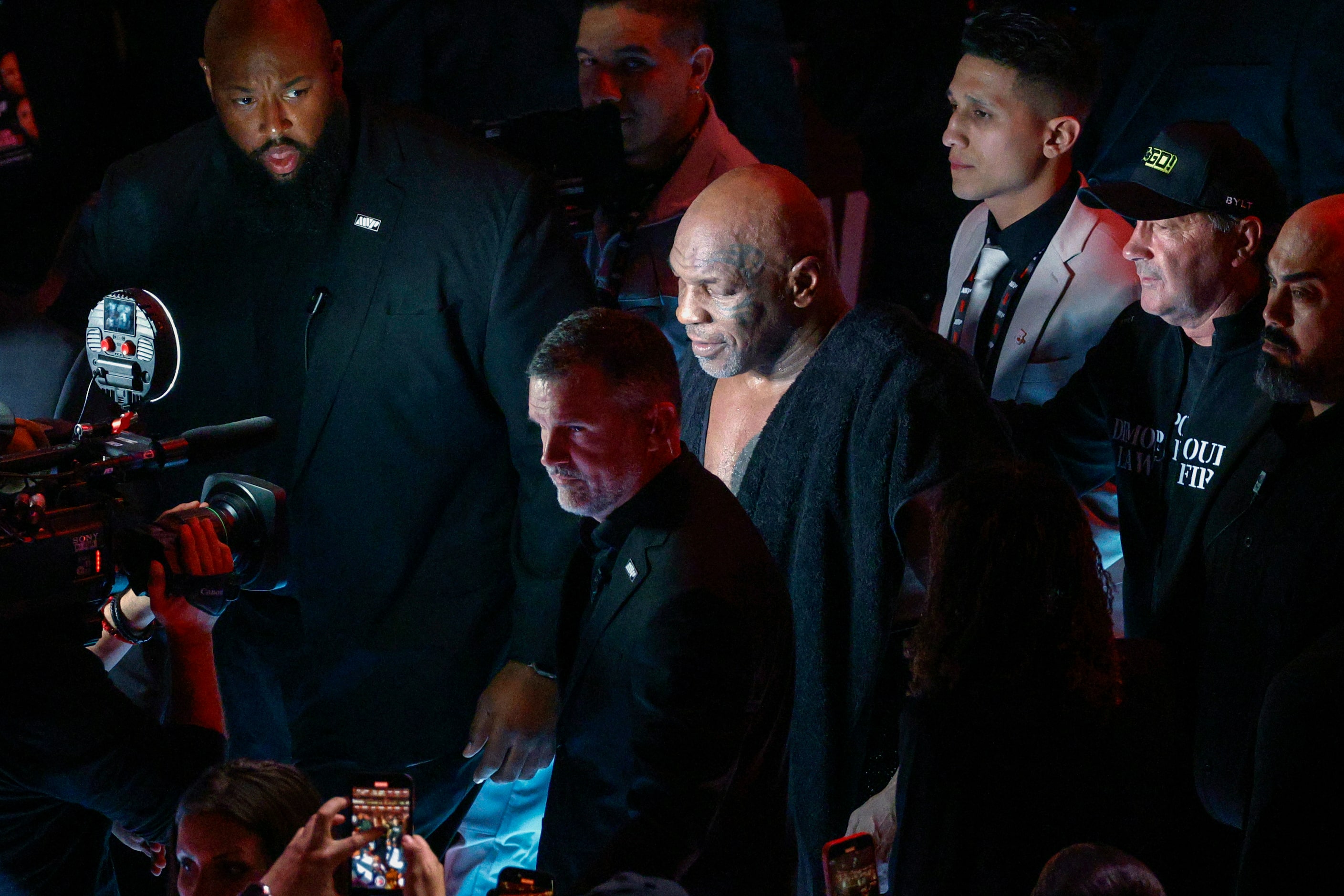 Mike Tyson exits the stadium floor after a heavyweight boxing match against Jake Paul,...