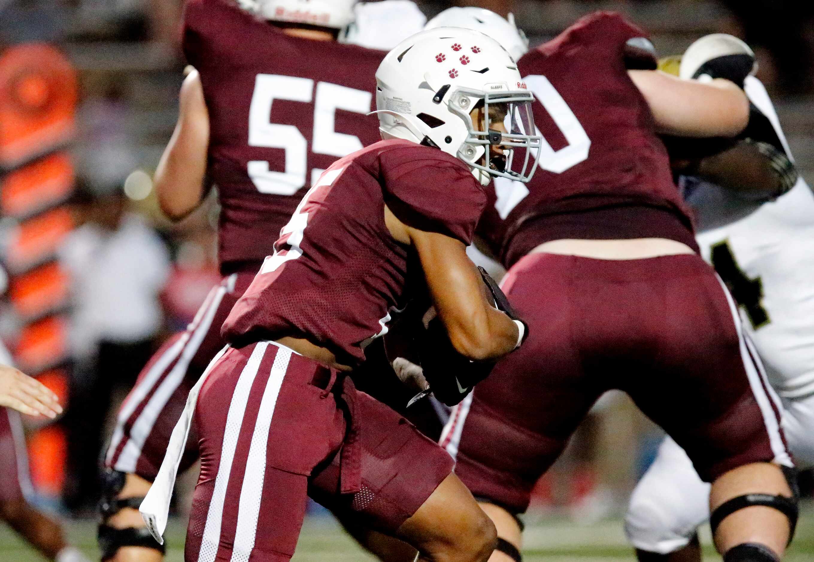 Plano Senior High School running back Joshua Campbell (15) runs behind his blocks during the...