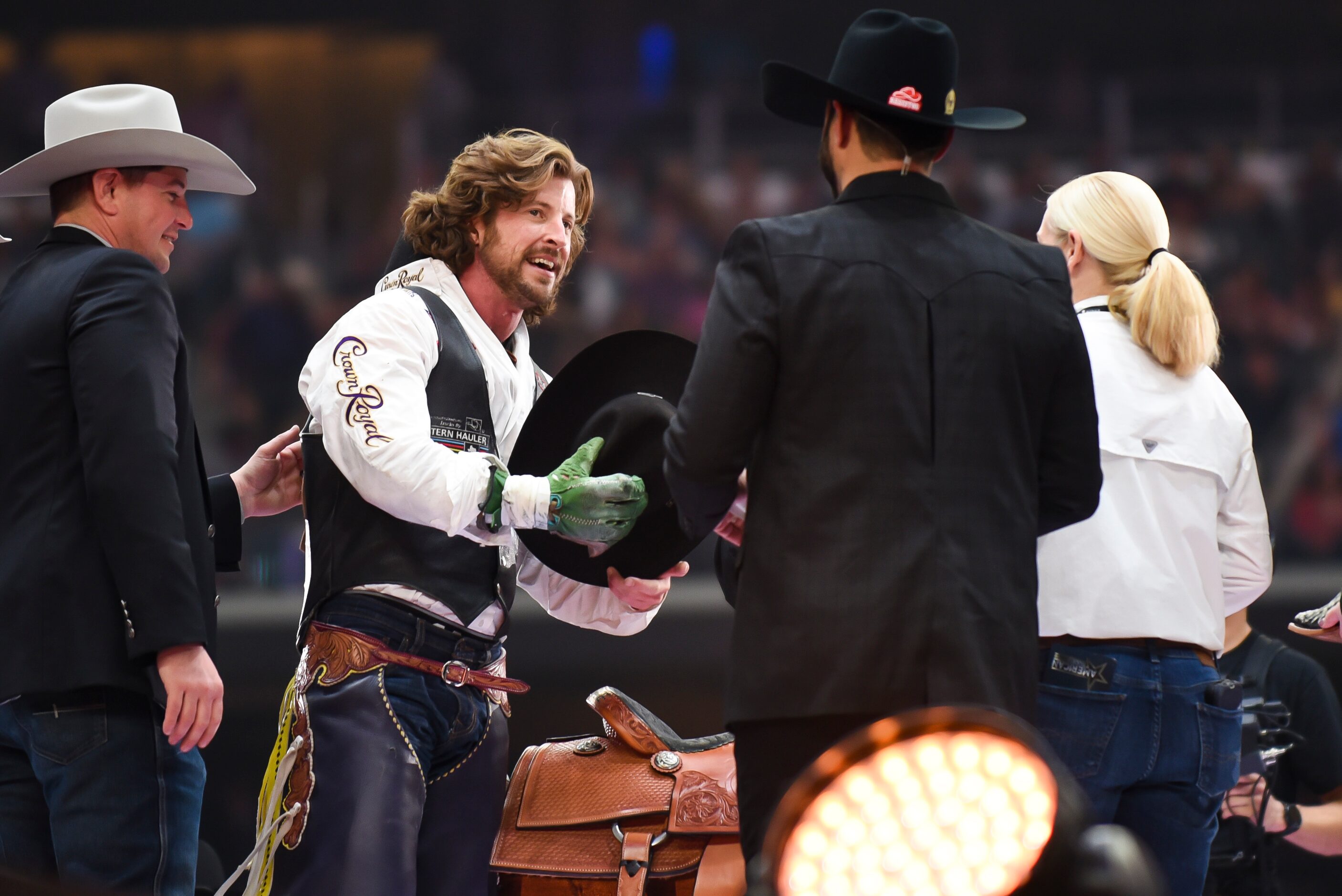 Tilden Hopper is recognized as the winner of the Bareback Bronc event during the...