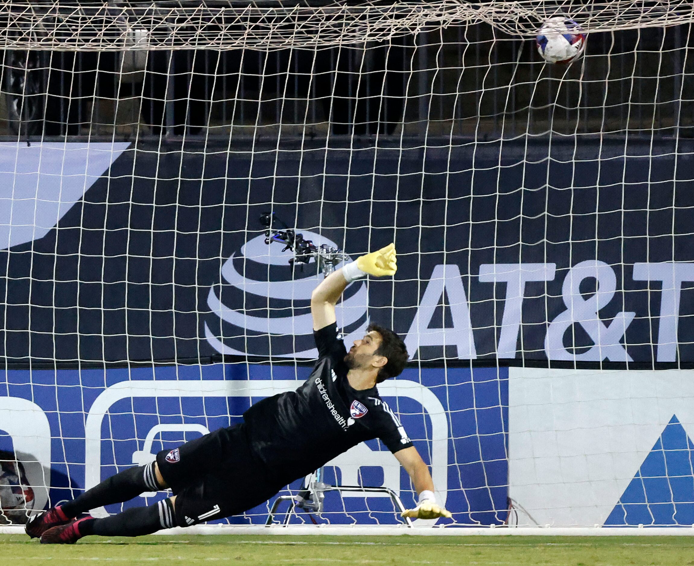 FC Dallas goalkeeper Jimmy Maurer (1) lets the first Charlotte FC penalty kick get past him...