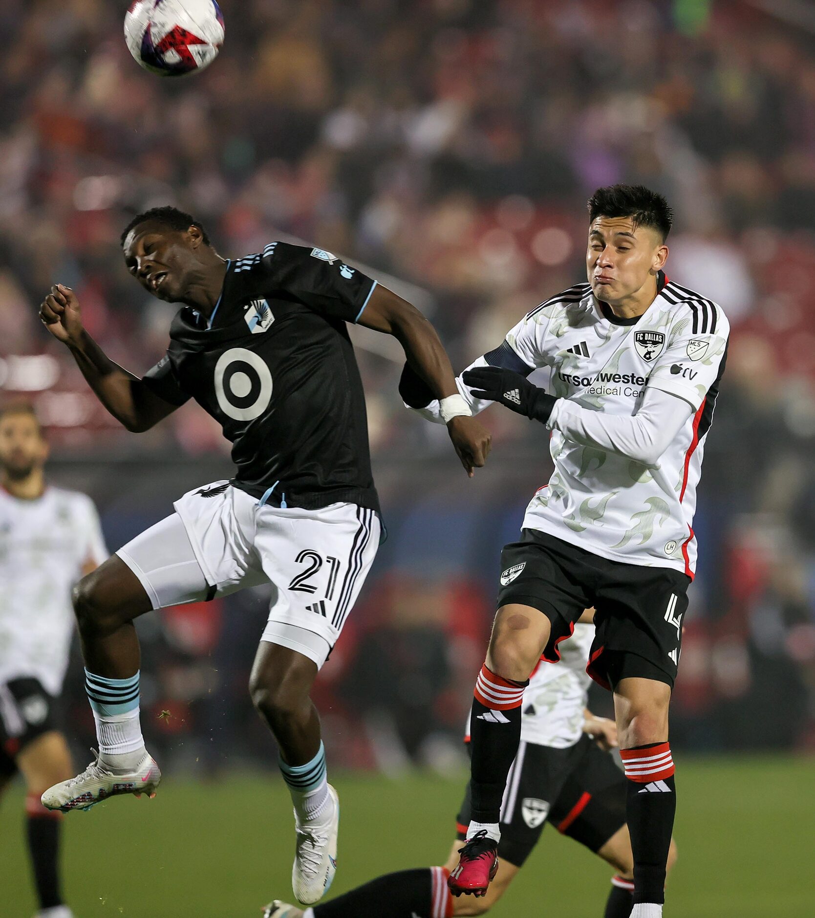 Minnesota United attacker Bongokuhle Hlongwane (21) heads the ball away from FC Dallas...