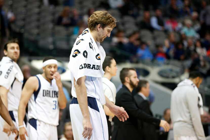 Dallas Mavericks forward Dirk Nowitzki (41) and other players walk off the court after...