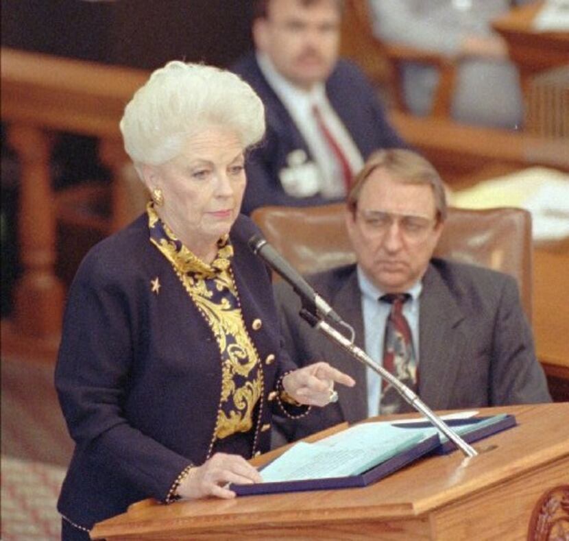 Gov. Ann Richards, flanked by Speaker of the House Pete Laney, goes over specific points in...