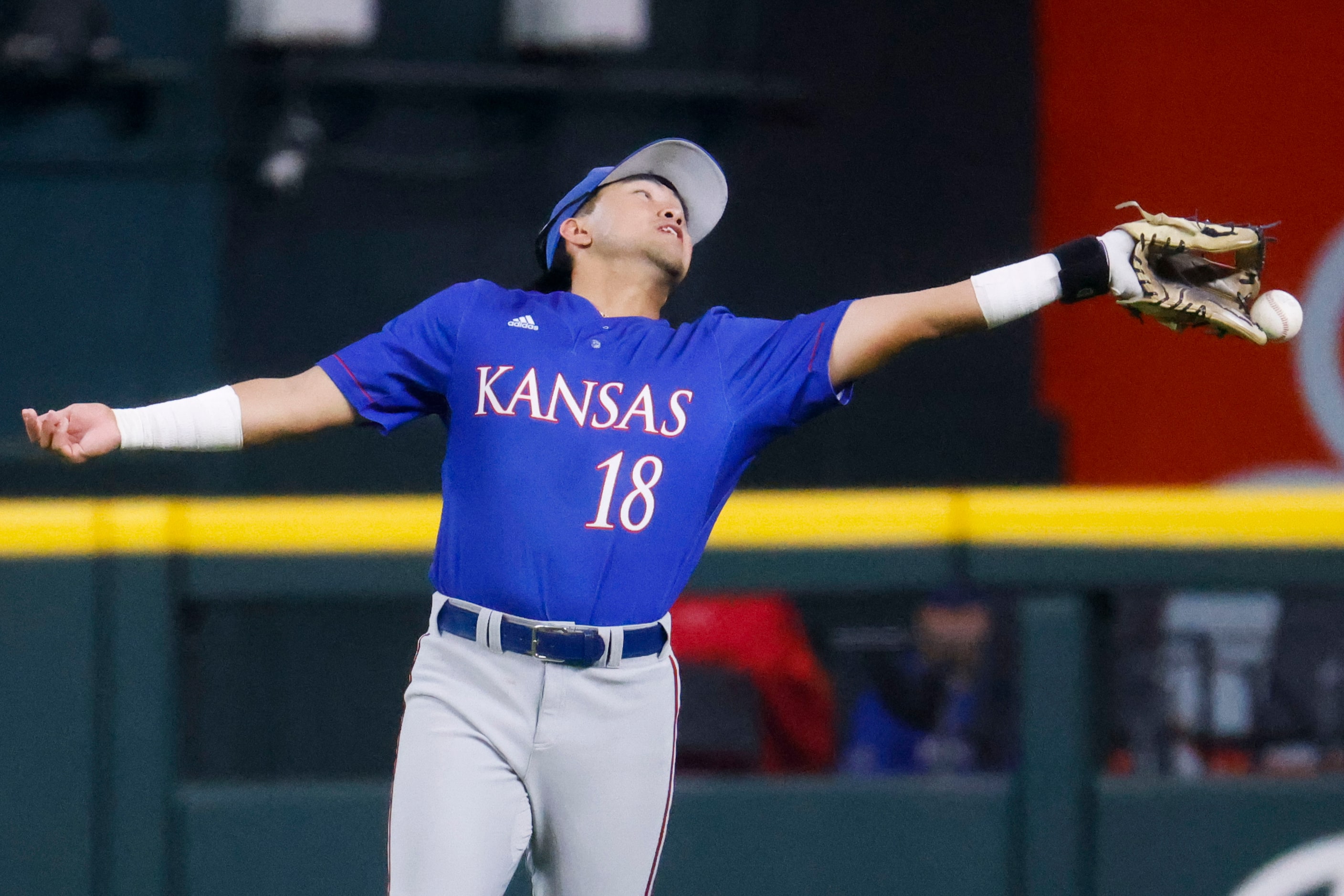 Kansas infielder Kodey Shojinaga misses to catch of Kansas St. infielder Kaelen Culpepper...