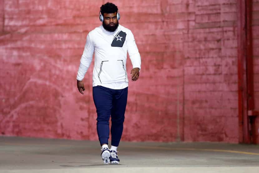 Dallas Cowboys running back Ezekiel Elliott (21) makes his way to the field to warmup before...