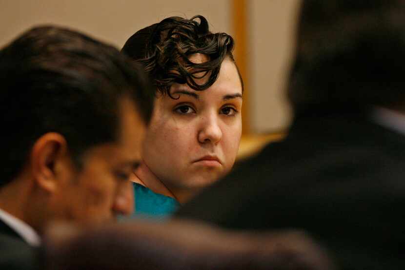 Defendant Jennifer Mee looks at her defense team during her trial on Friday, Sept. 20, 2013,...