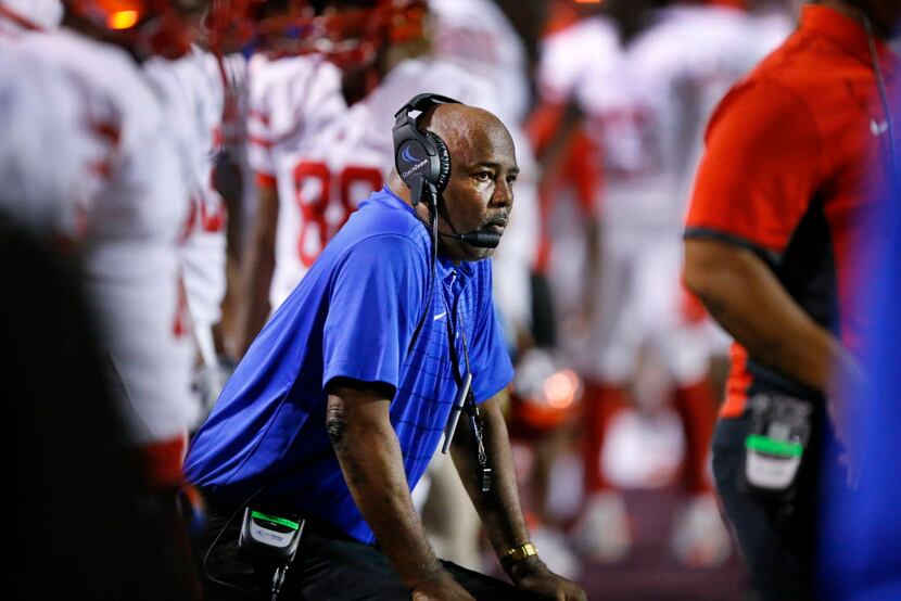 Duncanville head coach Reginald Samples coaches his players from a stool on the sideline as...