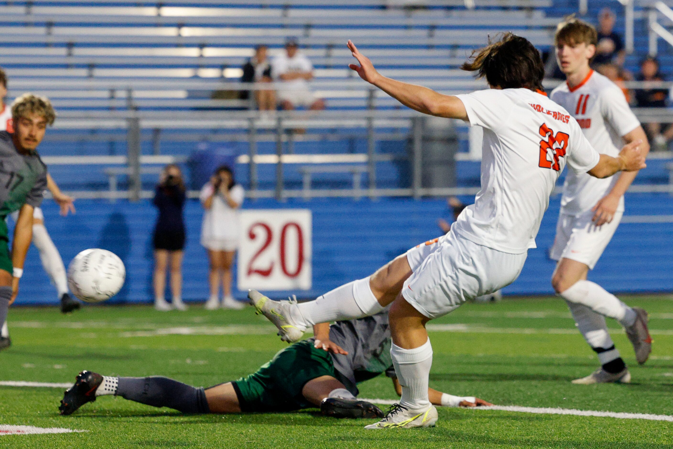 Frisco Wakeland forward Brennan Bezdek (22) scores a goal over a diving Fort Worth Trimble...