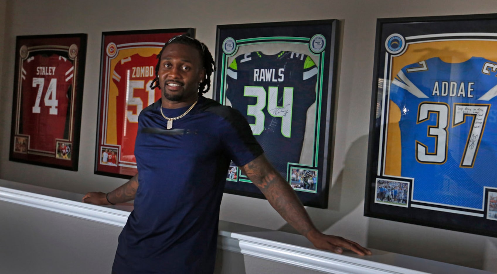 Dallas Cowboys defensive back Kavon Frazier shows off some of the opponents' jerseys he has...