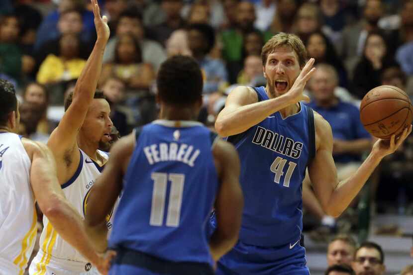 Dallas Mavericks forward Dirk Nowitzki (41) of Germany looks to pass to teammate Yogi...