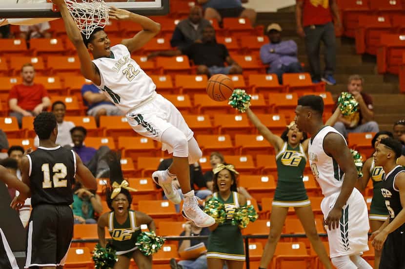 DeSoto's Marques Bolden (22) finishes the dunk next to South Grand Prairie's Cameron McGriff...
