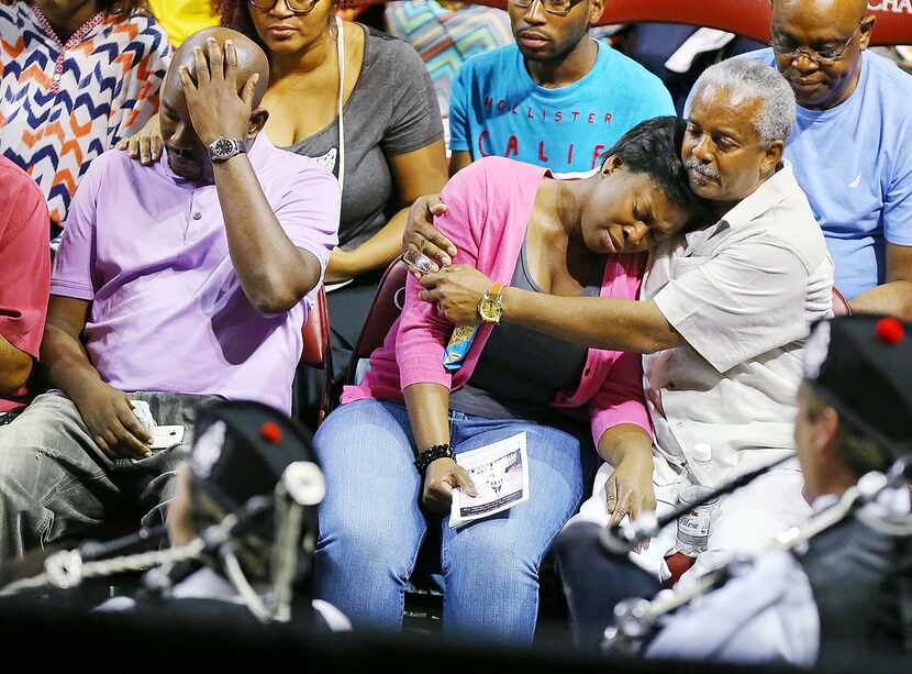 Family members of the shooting victims react as the Charleston Pipe and Drum play "Amazing...