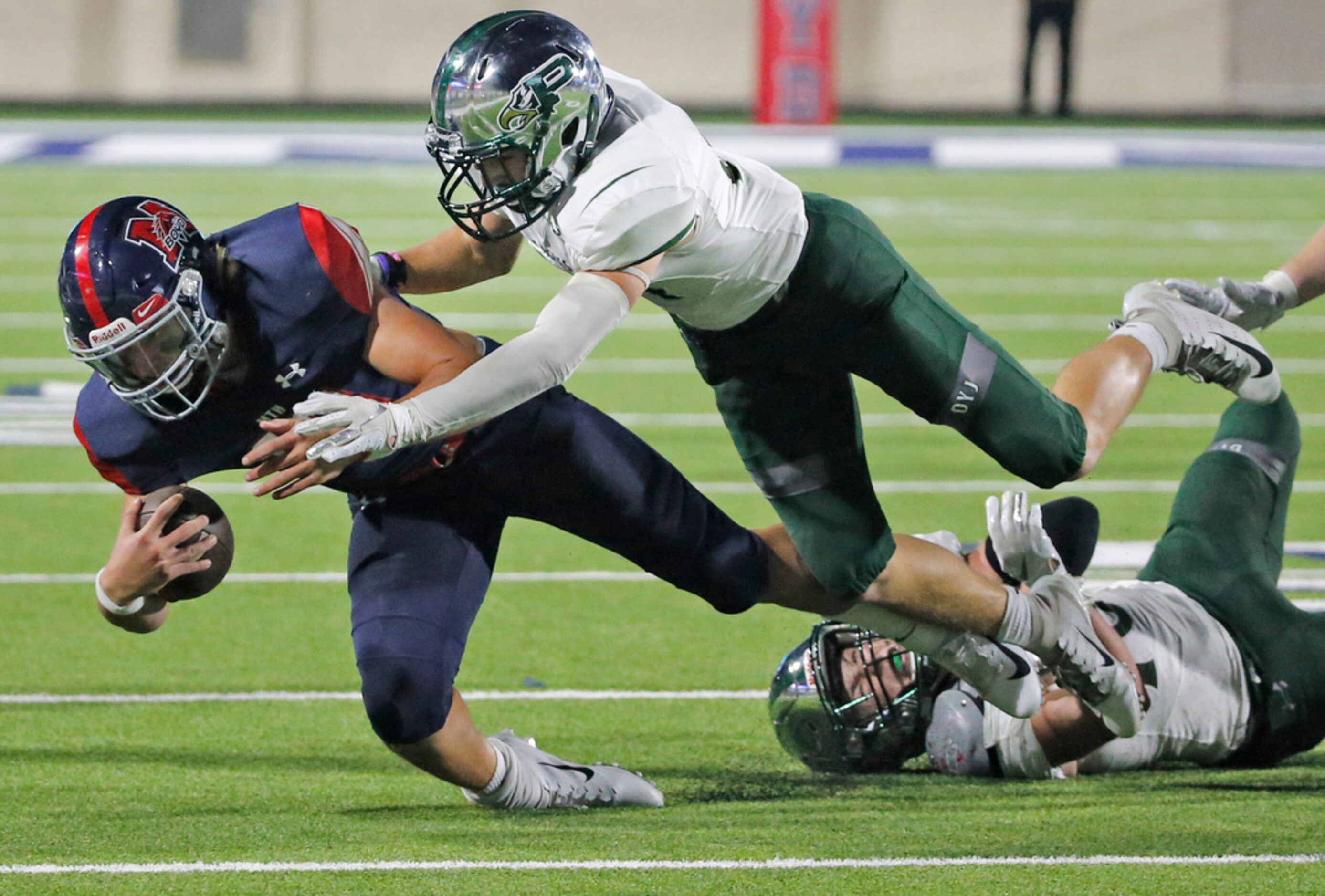 Boyd quarterback Collin Drake (18) is brought down by Prosper's Caleb Cox (14) in the second...