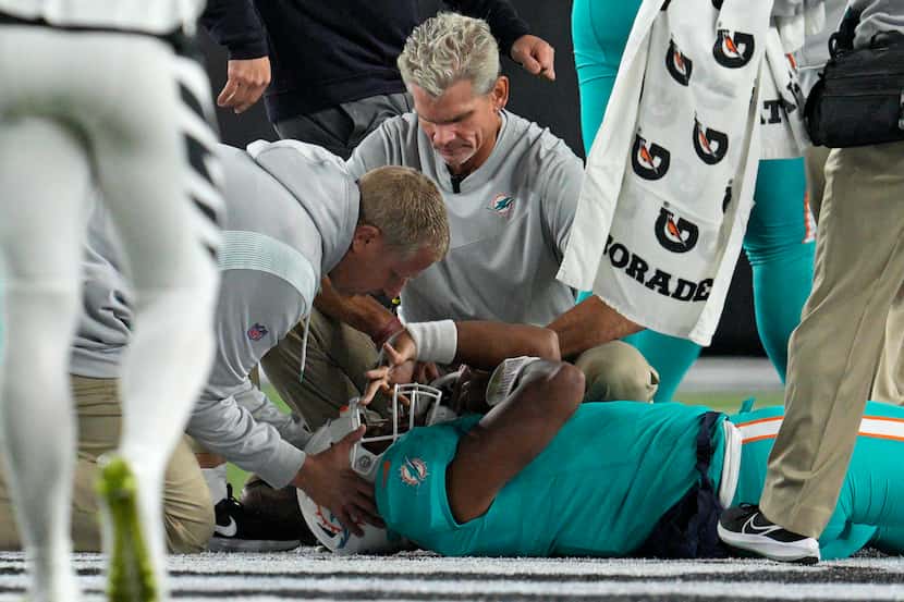 Miami Dolphins quarterback Tua Tagovailoa is examined during the first half of the team's...